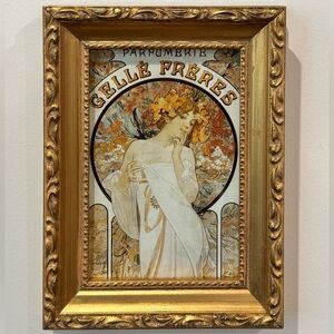 Small Alphonse Mucha wall art in gilded vintage frame.
